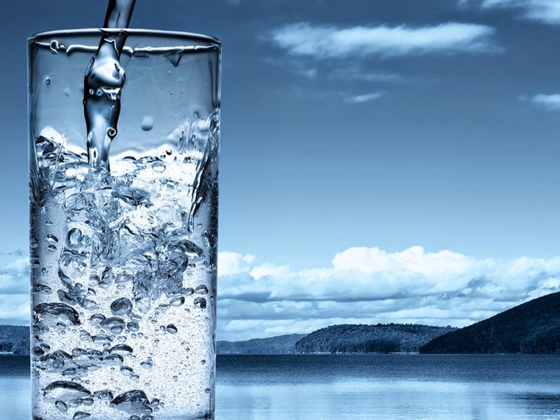 Hands pouring fresh mineral water from a container at an alkaline water store in Las Vegas